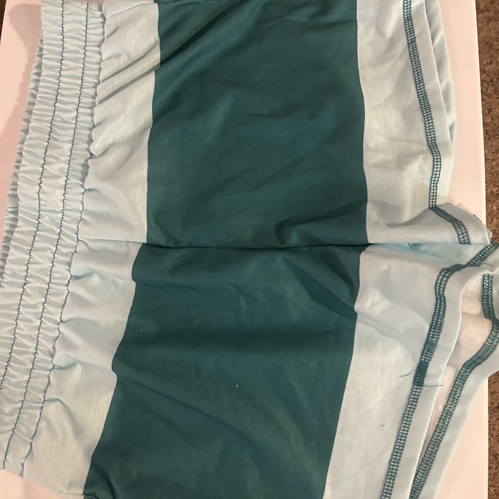 Teal and Light Blue Athletic Shorts & half zip top. Short sleeves with pockets.